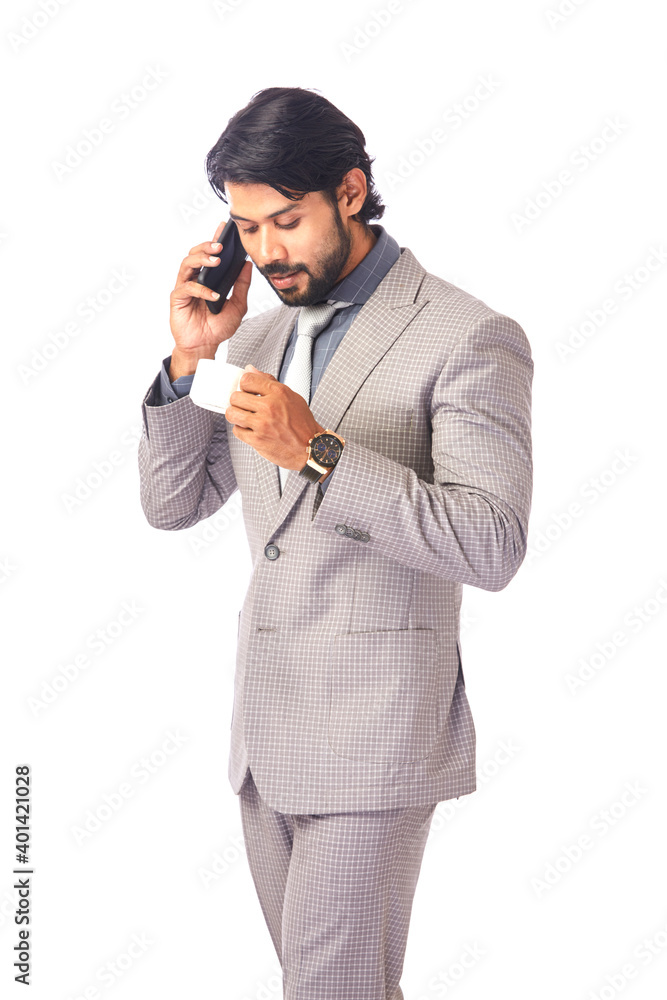Happy young businessman in talking in phone with cup of coffee on white. Happy young businessman in talking in phone with cup of coffee on white.