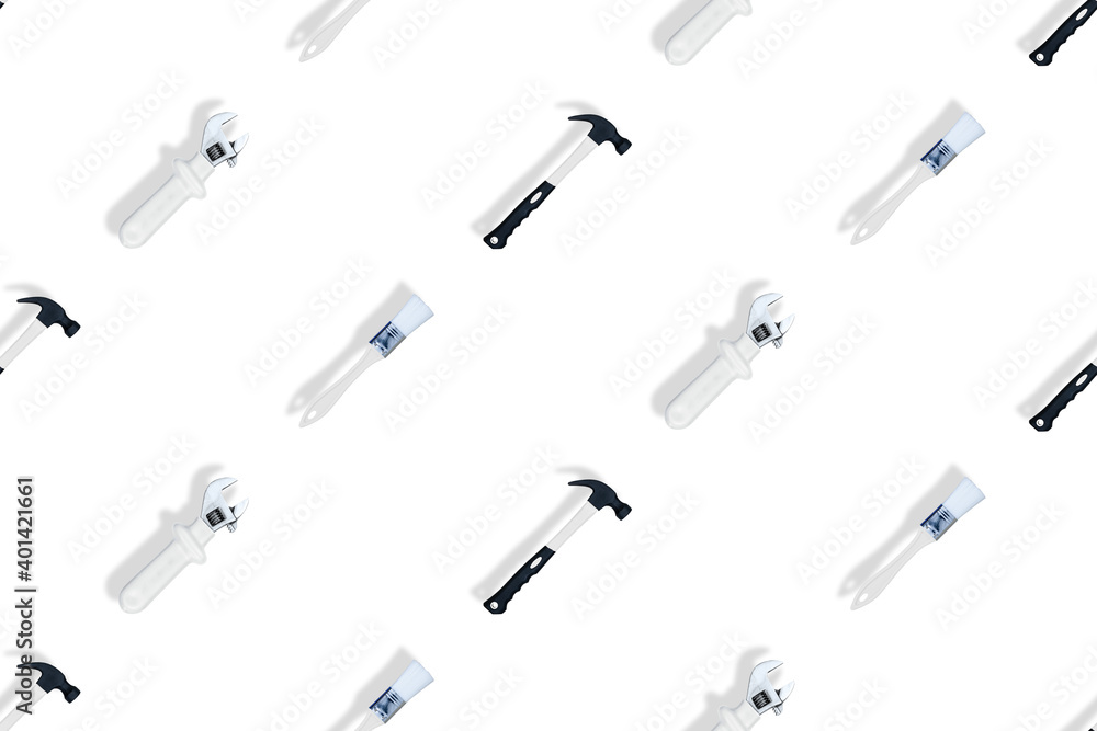 Tools seamless pattern. Tools: construction brushes, hammer, wrench on a white background. Tools seamless pattern. Tools: construction brushes, hammer, wrench on a white background.