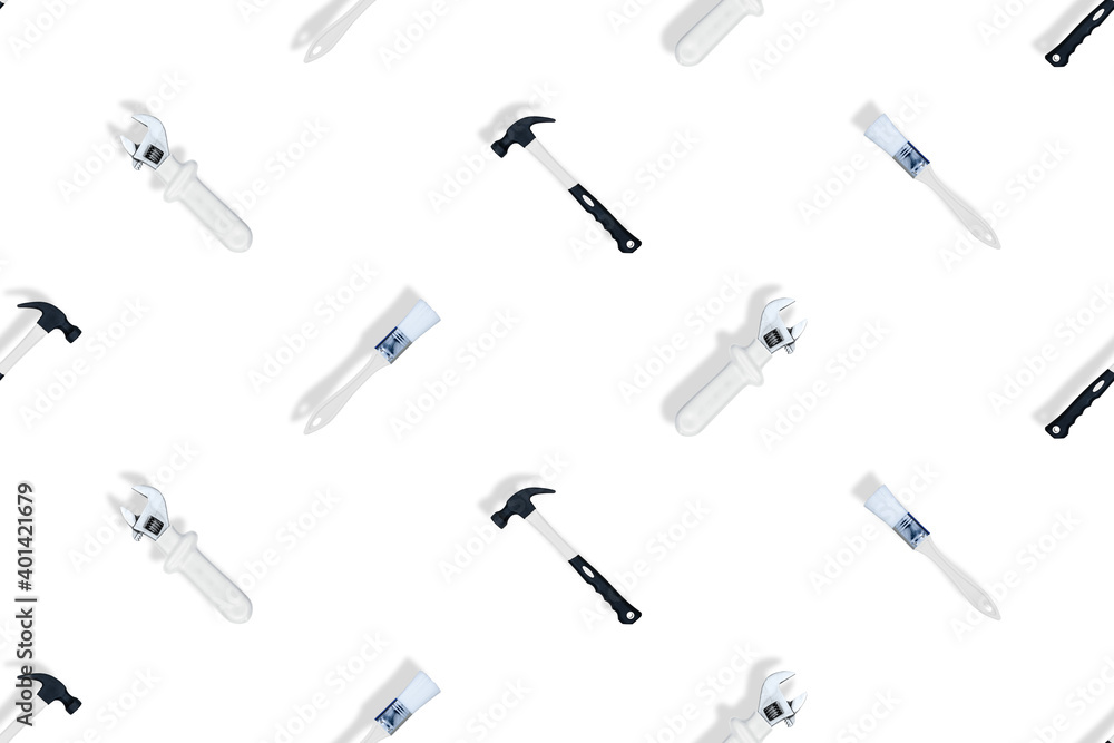 Tools seamless pattern. Tools: construction brushes, hammer, wrench on a white background. Tools seamless pattern. Tools: construction brushes, hammer, wrench on a white background.