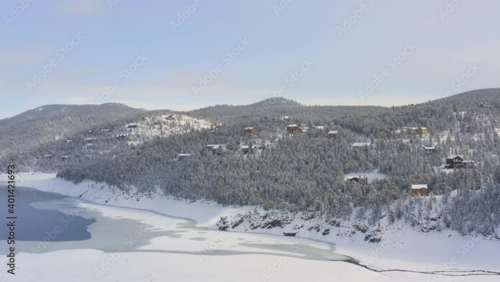epic drone shot of cabins on mountain landscape in colorado during winter epic drone shot of cabins on mountain landscape in colorado during winter