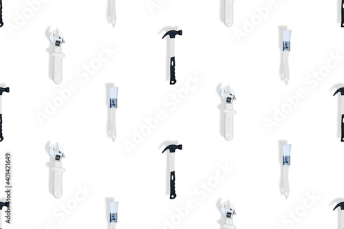 Tools seamless pattern. Tools: construction brushes, hammer, wrench on a white background.