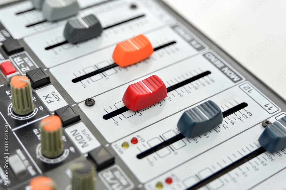 Widened faders on different sides on a mixing console, close-up. Widened faders on different sides on a mixing console, close-up.