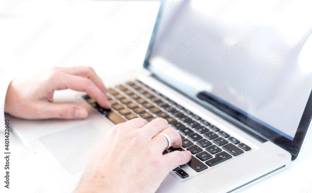 Close hands of married boy working on modern laptop Close hands of married boy working on modern laptop