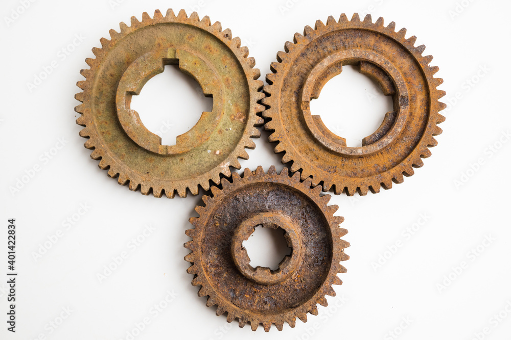 Rusty gears from an old mechanism on a white background, photographed up close. Rusty gears from an old mechanism on a white background, photographed up close.