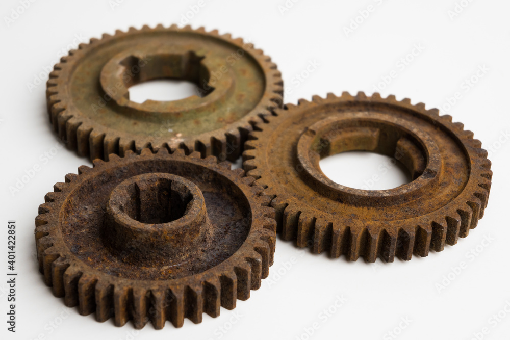 Rusty gears from an old mechanism on a white background, photographed up close. Rusty gears from an old mechanism on a white background, photographed up close.