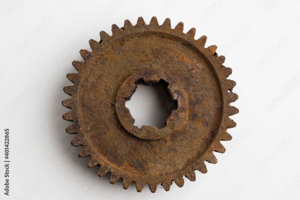 Rusty gear from an old mechanism on a white background, photographed up close. Rusty gear from an old mechanism on a white background, photographed up close.