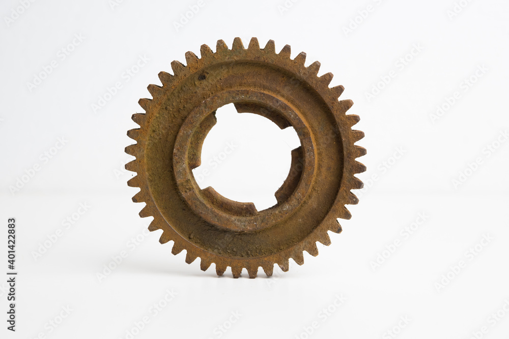 Rusty gear from an old mechanism on a white background, photographed up close. Rusty gear from an old mechanism on a white background, photographed up close.