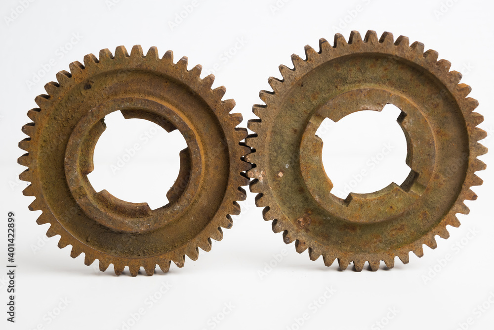 Rusty gears from an old mechanism on a white background, photographed up close. Rusty gears from an old mechanism on a white background, photographed up close.