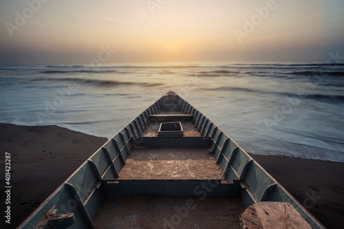 Boat on the beach at sunrise time photo