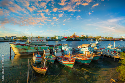 fishing boats under a sunset in a fishing harbor photo