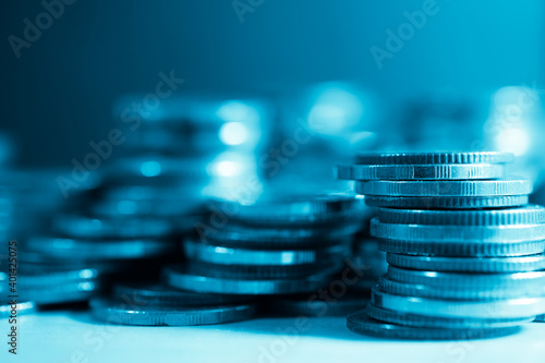 rows of coins and blurred bokeh for finance and banking concept