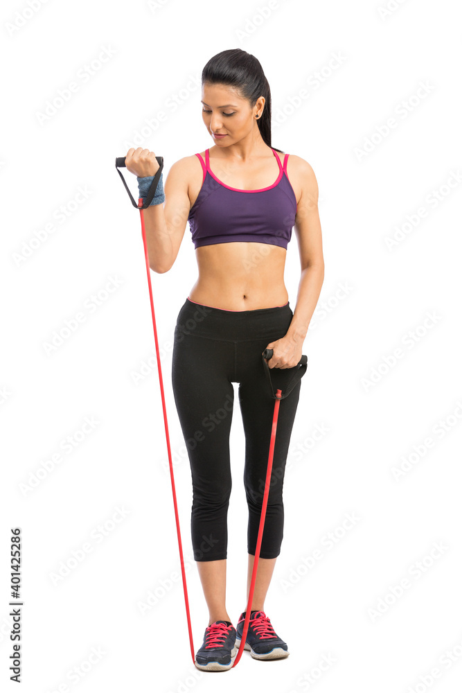 young fit women working out with rubber band over white background young fit women working out with rubber band over white background