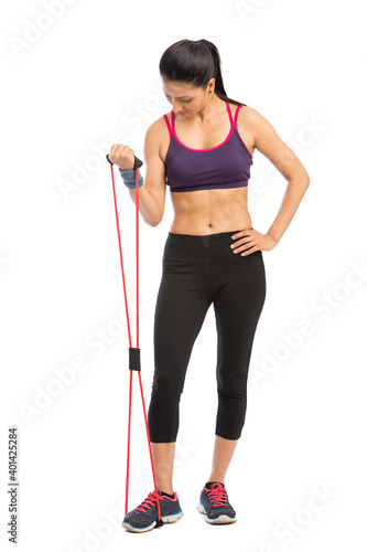young fit women working out with rubber band over white background