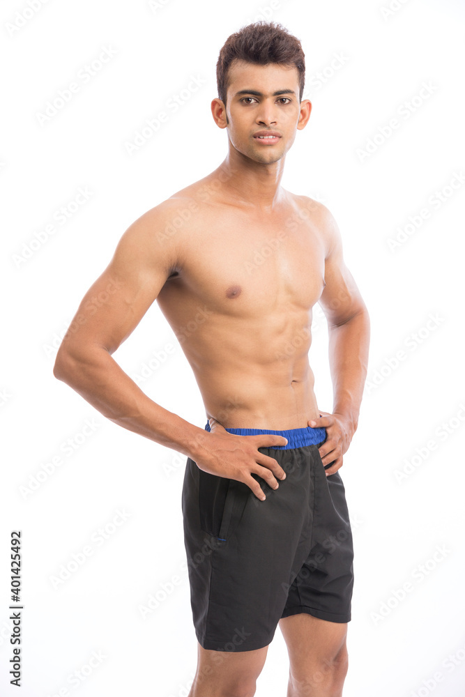 healthy athletic young man showing muscle isolated on white. healthy athletic young man showing muscle isolated on white.