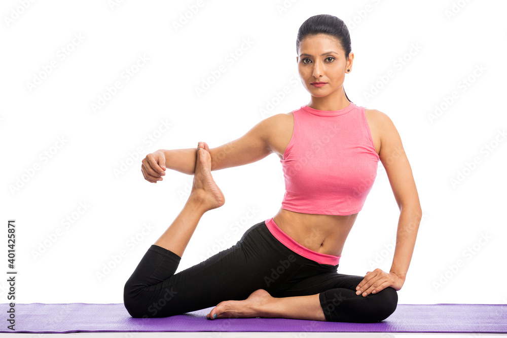 Fototapeta premium Beautiful young woman doing yoga isolated on white background.