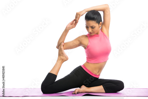 Beautiful young woman doing yoga isolated on white background.