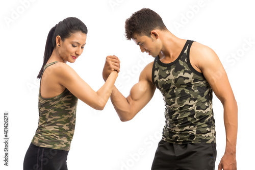 Two sportive people in sportswear showing their biceps, isolated on white background