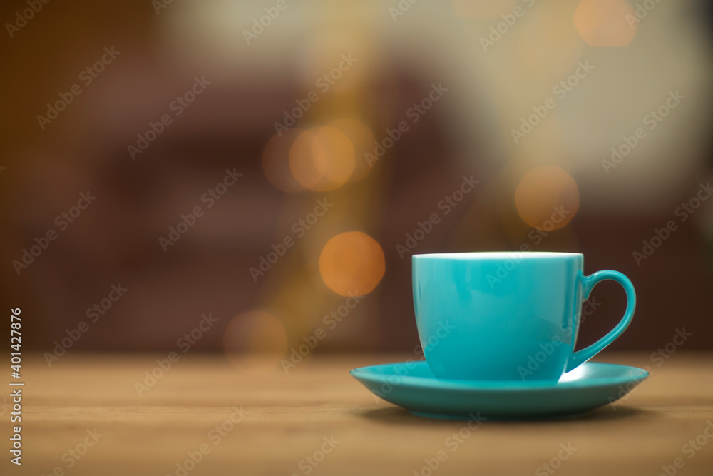 Teal tea cups on table at home.