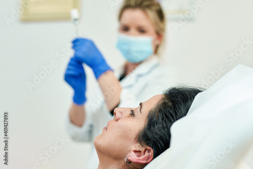 Portrait of beautician doctor with syringe in hand. Cosmetologist holding medical tools. Beauty clinic or hospital.