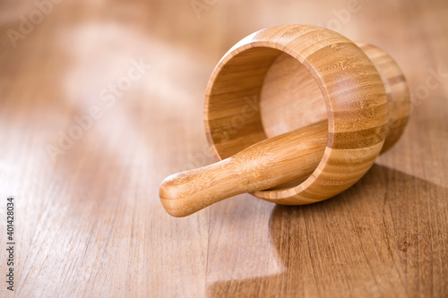 Mortar with pestle on wooden table
