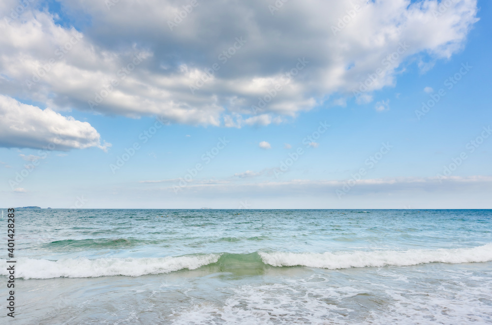 Fototapeta premium Sea waves and blue sky on sunny day background. copy space