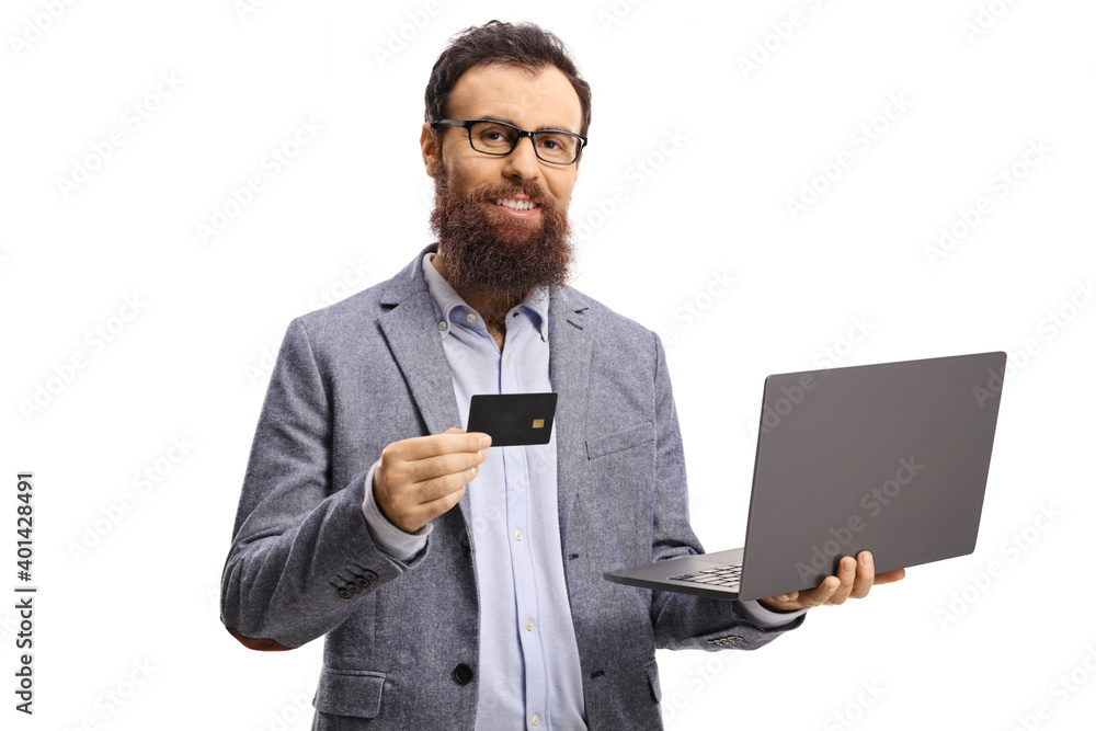 Bearded man holding a credit card and a laptop computer Bearded man holding a credit card and a laptop computer