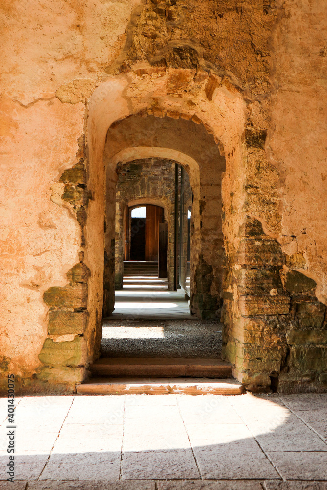 Enfilade of old stone arch in ruined medieval castle