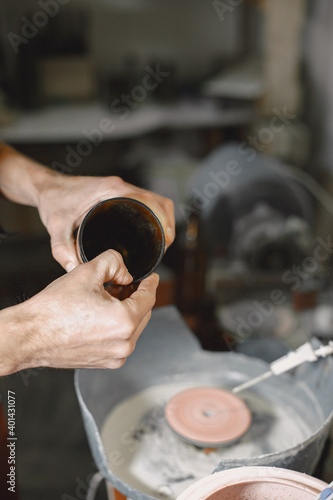 Hand worker with empty bottle. Man's hand close-up.The concept of production.