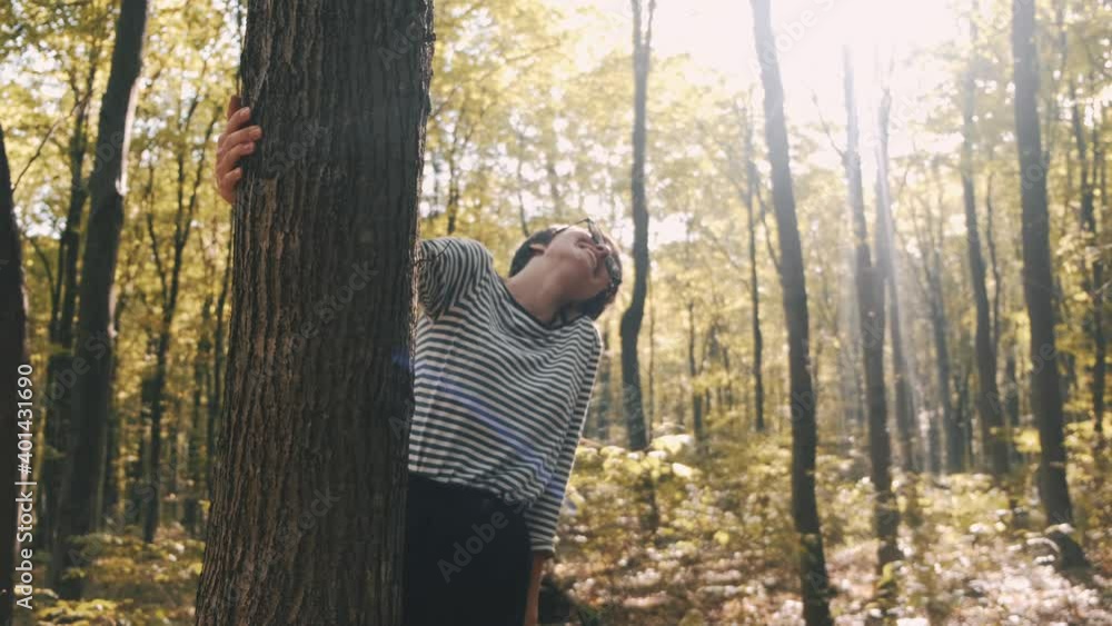 Beautifull tall woman in stylish wear walks in the forest. She enjoys the warmth of pretty autumn sunset. Beautifull tall woman in stylish wear walks in the forest. She enjoys the warmth of pretty autumn sunset.