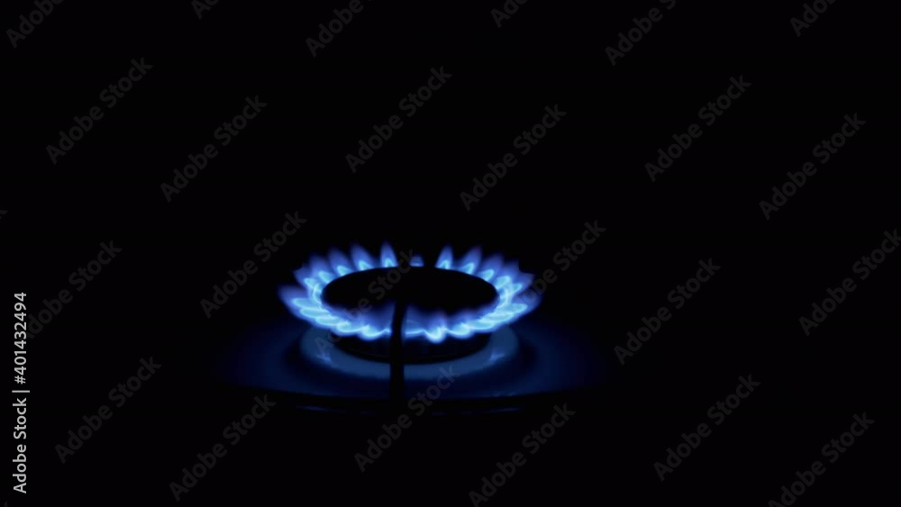 Turn on Gas Burner, Blazing with a Blue Flame, at Night in Kitchen. Close-Up Turn on Gas Burner, Blazing with a Blue Flame, at Night in Kitchen. Close-Up