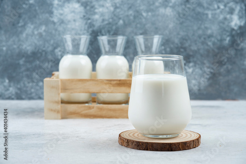A glasses of milk on a gray background