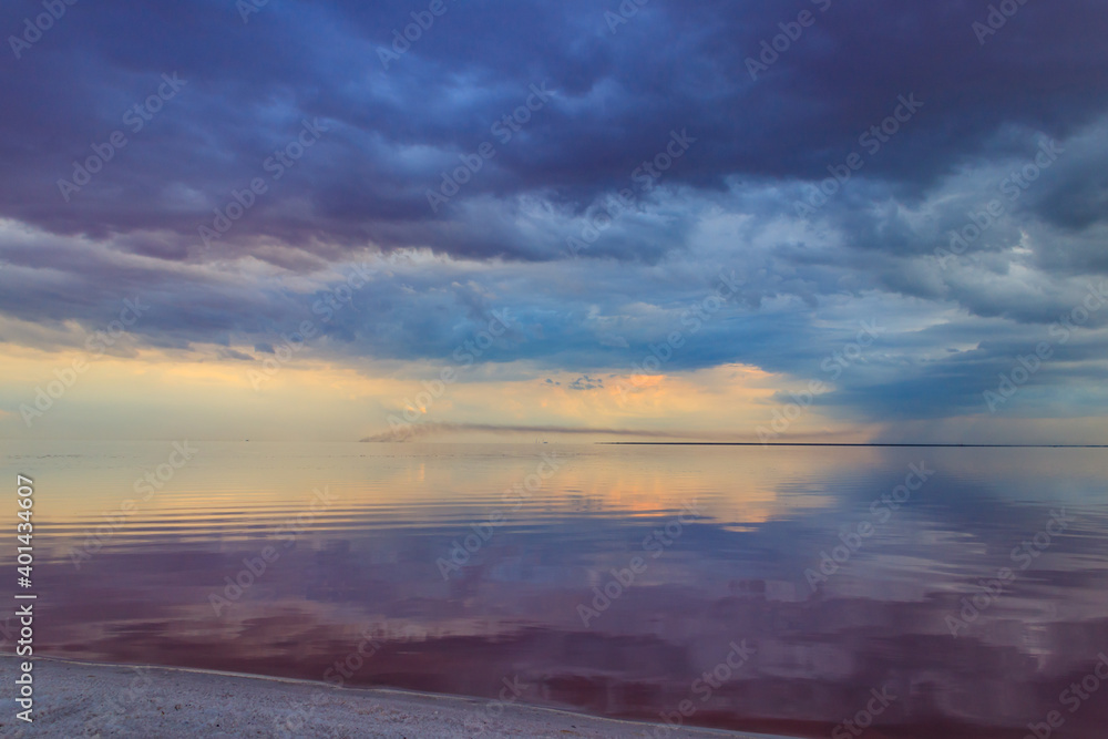 Dark storm clouds over a salt lake before a rain Dark storm clouds over a salt lake before a rain