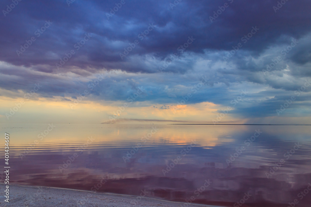 Dark storm clouds over a salt lake before a rain