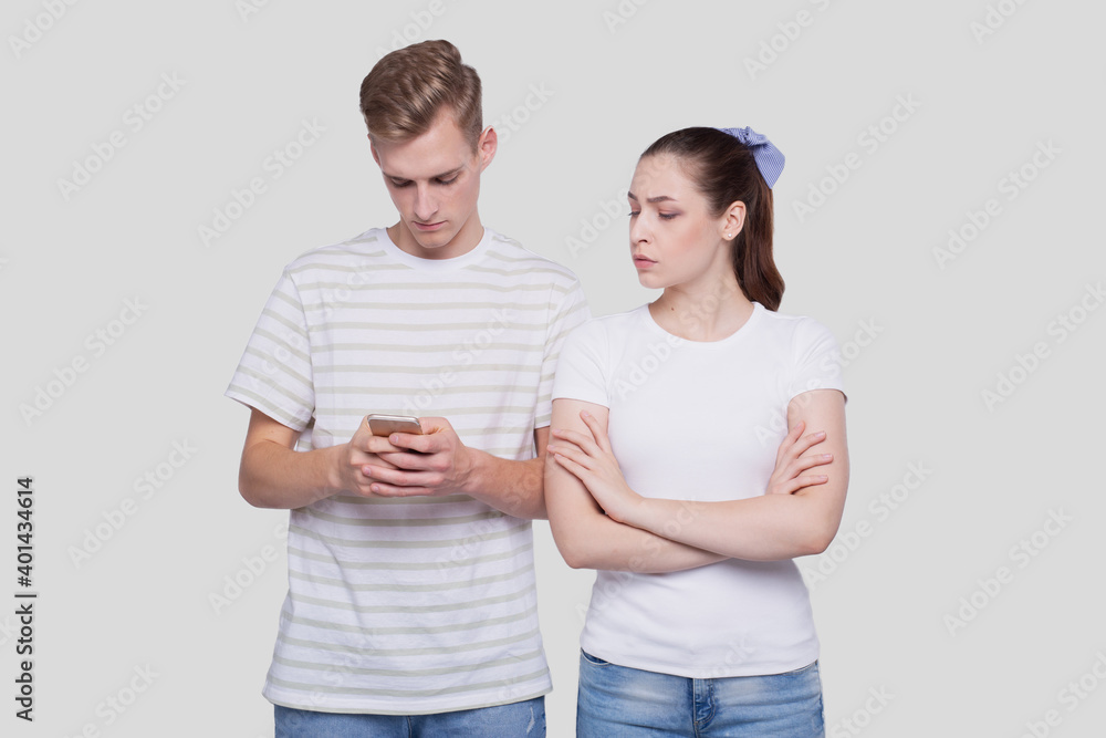 Man Chatting on Phone. Couple Using Phones Standing Isolated. Couple Shopping Online. Girl Watching in Man Phone. Secret in Phone. Man Chatting on Phone. Couple Using Phones Standing Isolated. Couple Shopping Online. Girl Watching in Man Phone. Secret in Phone.
