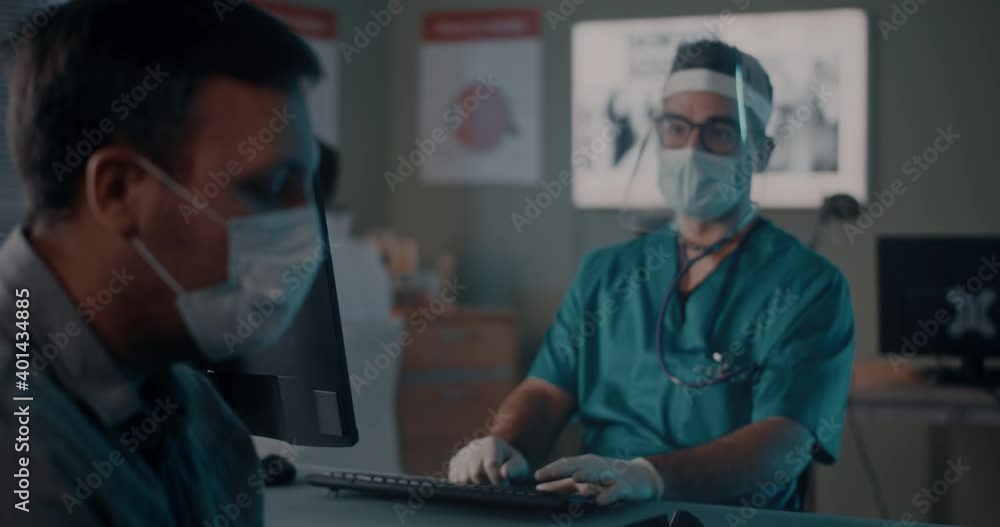Male patient in mask speaking with doctor Male patient in mask speaking with doctor