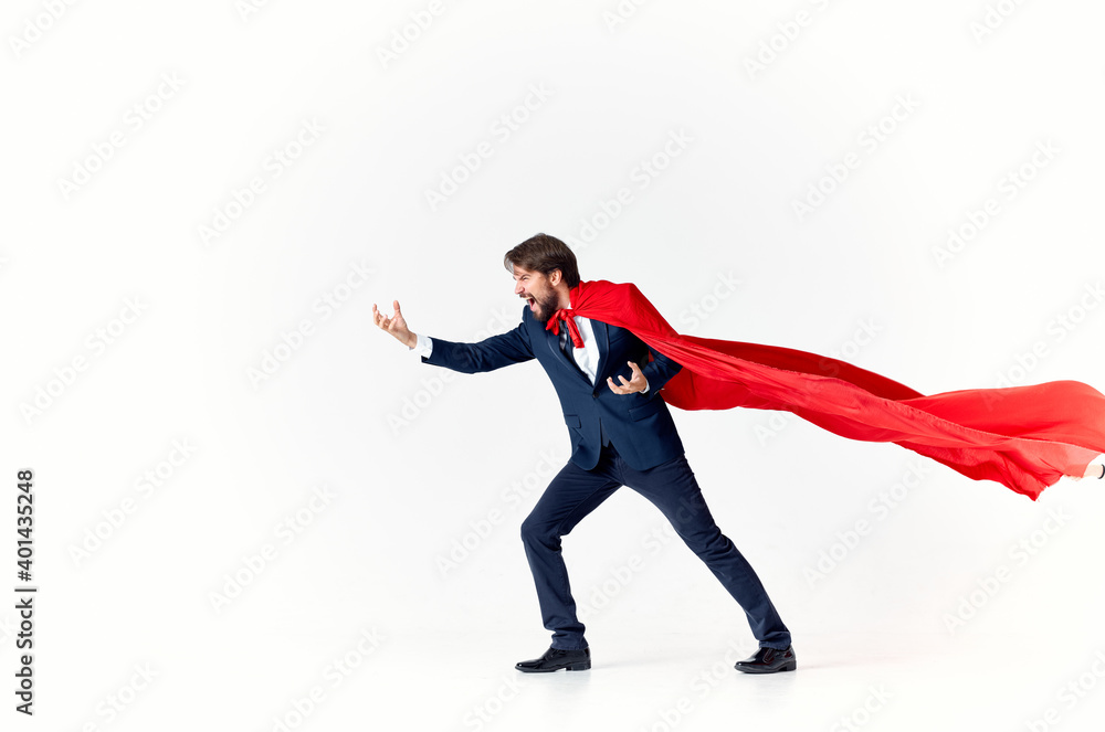 business man in a red cloak on a light background gesturing with his hands flying success advertising