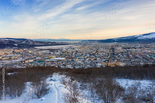 View of the city of Magadan. Northern city on the coast of the Sea of ​​Okhotsk. Beautiful winter cityscape. Top view of the streets and buildings. Magadan, Magadan Region, Siberia, Far East of Russia