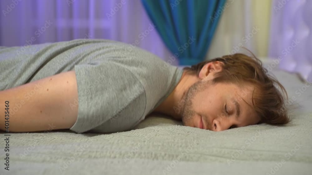 Tired overworked young man flopped down on sofa. Slow motion Tired overworked young man flopped down on sofa. Slow motion