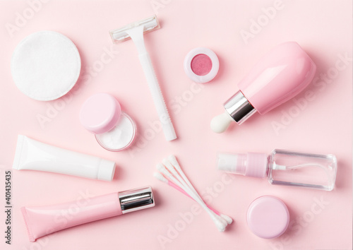 Face care products (tonic or lotion, serum, cream, micellar water, cotton pads and sticks, shaver) on powder background. Freshness and body care. Skin care and anti-age care. Female everyday cosmetics