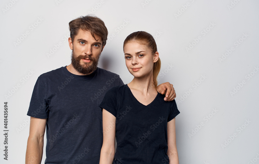 Obraz premium young couple in black t-shirts and jeans studio lifestyle elegant style