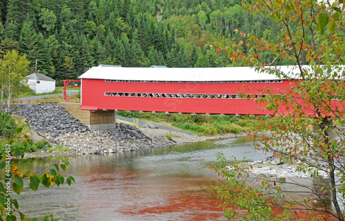 Quebec; Canada- june 25 2018 : a red covered bridge on Matapedia river photo