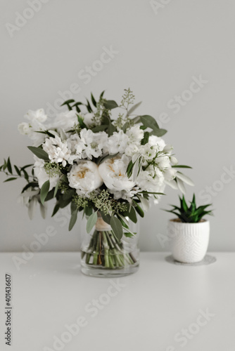a beautiful wedding bouquet stands in a vase of water. the bride's bouquet. florist. wedding decorations. mothers Day. March 8. flowers