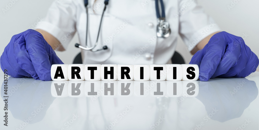 The doctor put together a word from cubes ARTHRITIS The doctor put together a word from cubes ARTHRITIS