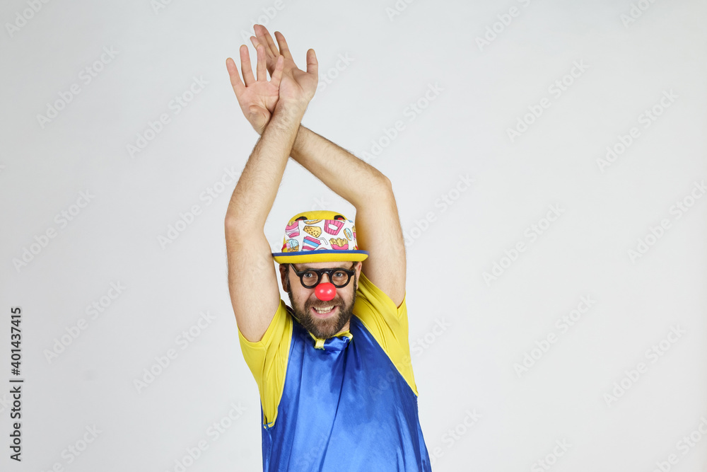 The clown is a man in a bright blue and yellow suit, glasses and a hat, playing emotionally. The clown is a man in a bright blue and yellow suit, glasses and a hat, playing emotionally.