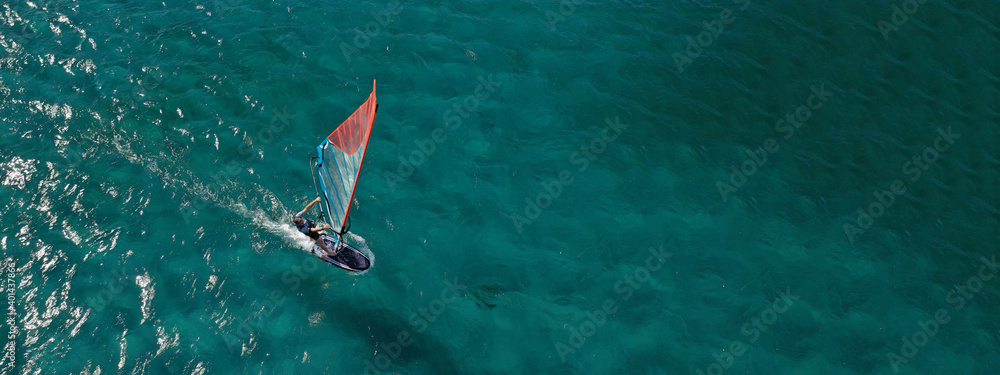 Aerial drone ultra wide photo of professional wind surfer practice in deep blue open ocean sea - obrazy, fototapety, plakaty 