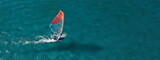 Aerial drone ultra wide photo of professional wind surfer practice in deep blue open ocean sea
