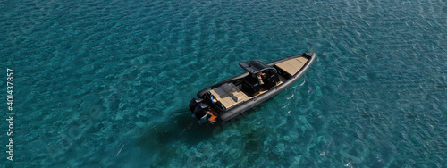 Aerial drone ultra wide photo of inflatable rib power boat anchored in tropical exotic emerald crystal clear sea bay © aerial-drone