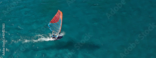 Aerial drone ultra wide photo of professional wind surfer practice in deep blue open ocean sea