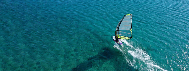 Aerial drone ultra wide photo of professional wind surfer practice in deep blue open ocean sea