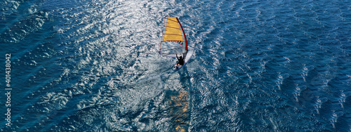 Aerial drone ultra wide photo of professional wind surfer practice in deep blue open ocean sea © aerial-drone